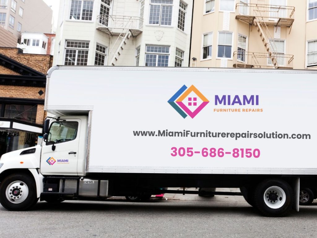 A white delivery truck displaying the logo and contact info of Miami Furniture Repair Solutions, parked in an urban location.