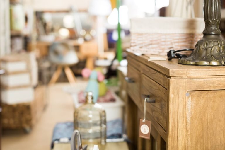 A room featuring an antique wooden dresser and a classic lamp, creating a warm and inviting atmosphere.